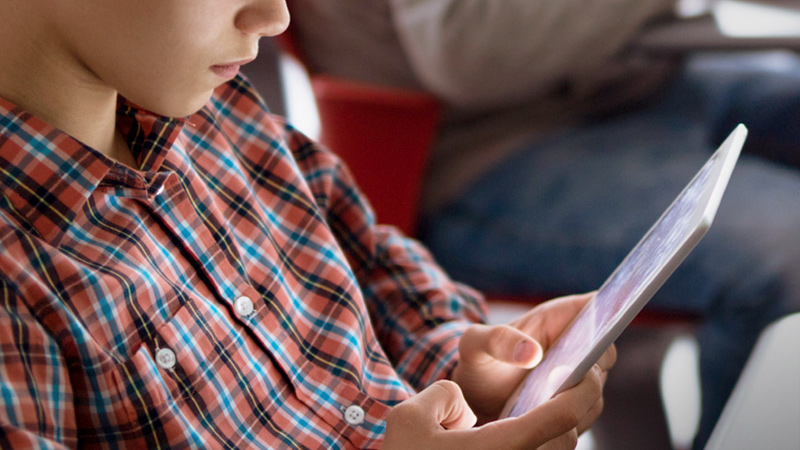 Student looking at a tablet.