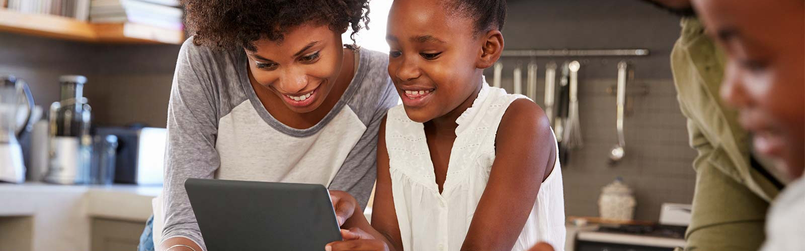 a mom and a daughter using a tablet together