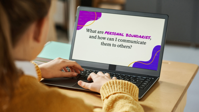 A girl with a blond ponytail looks at a laptop screen with a lesson about personal boundaries.