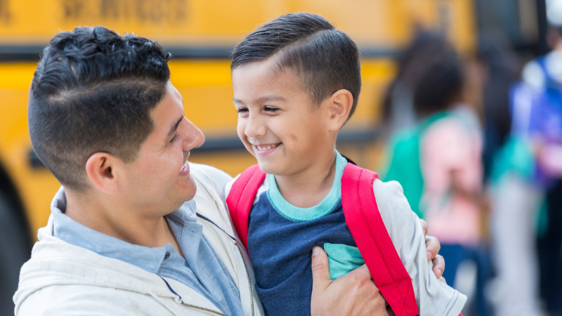 Latinx father and son at school