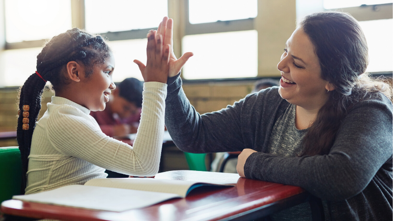 teacher giving student a high five