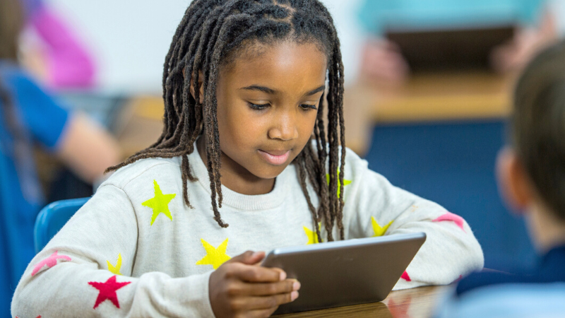 african american elementary student on a tablet