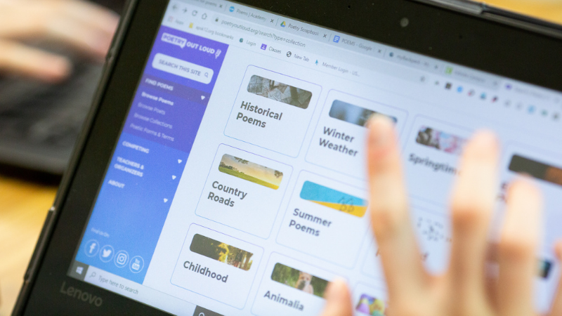 Photo of a student's hand using a Chromebook for learning