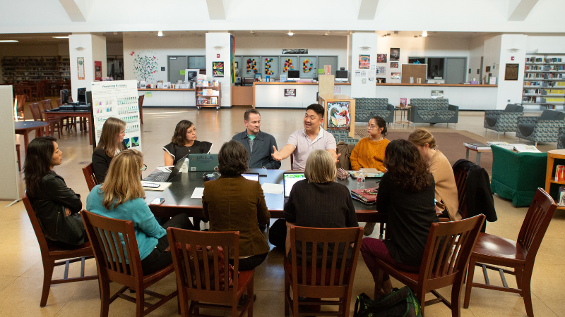 Photo of teachers meeting in a library