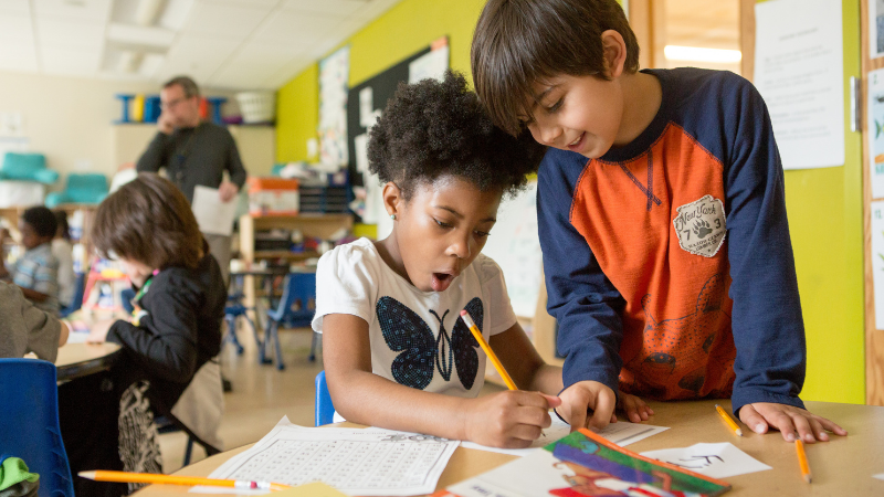 Two students doing a math worksheet in a classroom