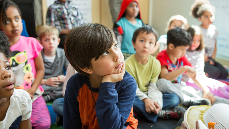 Photo of students listening to a teacher