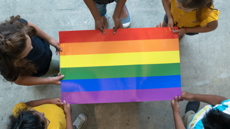 photo of students holding a pride flag