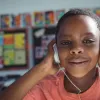 close up of boy in the classroom wearing headphones